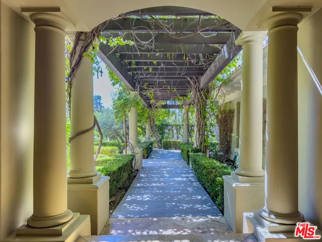 a view of a pathway of a house with a fountain