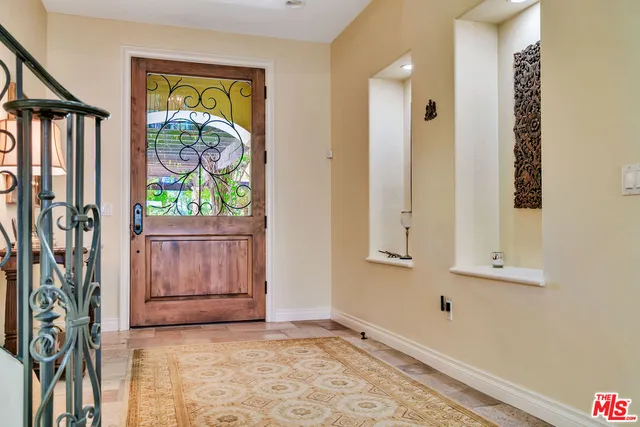 a view of an entryway with wooden floor