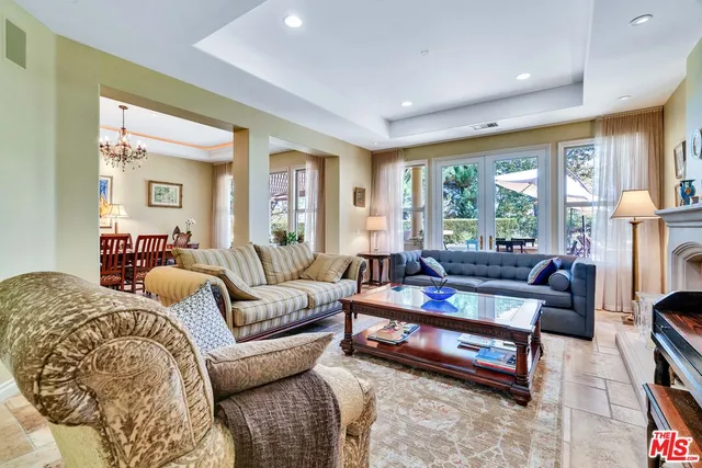 a living room with furniture fireplace and a large window