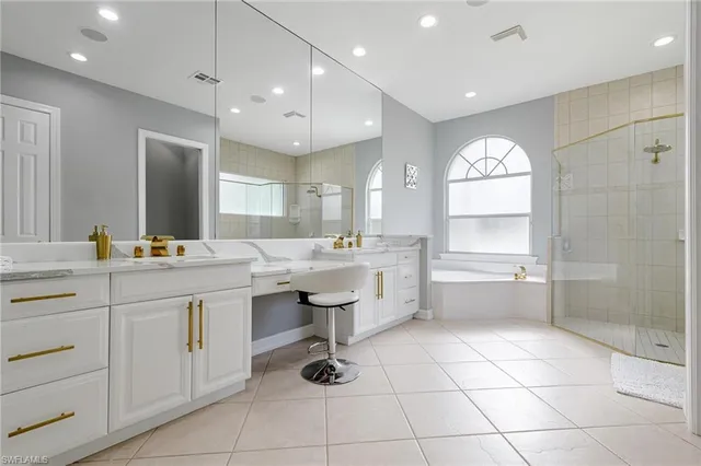 a kitchen with a sink a counter space appliances and a window