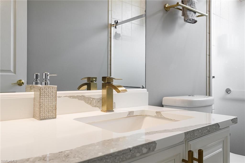 160 Logan Boulevard South Naples, FL 34119 - Photo 22 of 49 Bathroom featuring vanity and a shower with door
