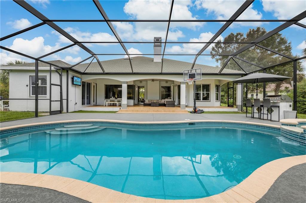 160 Logan Boulevard South Naples, FL 34119 - Photo 26 of 49 Outdoor pool featuring a sunroom, an outdoor hangout area, a patio, and a lanai
