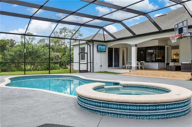 a view of a swimming pool with a couches in patio