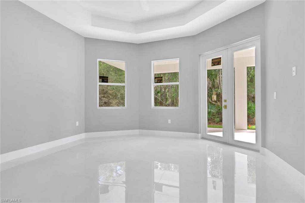 160 Logan Boulevard South Naples, FL 34119 - Photo 37 of 49 Unfurnished room featuring a tray ceiling