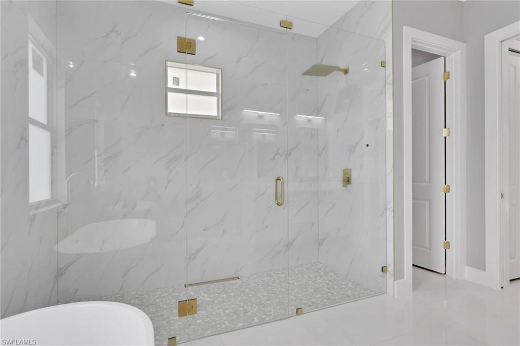 160 Logan Boulevard South Naples, FL 34119 - Photo 41 of 49 Full bath featuring a marble finish shower and a soaking tub