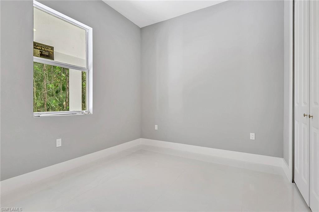 160 Logan Boulevard South Naples, FL 34119 - Photo 44 of 49 Empty room featuring baseboards