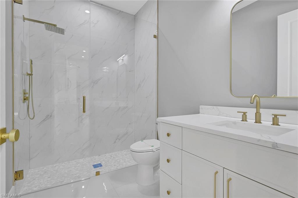 160 Logan Boulevard South Naples, FL 34119 - Photo 45 of 49 Bathroom featuring vanity and a marble finish shower