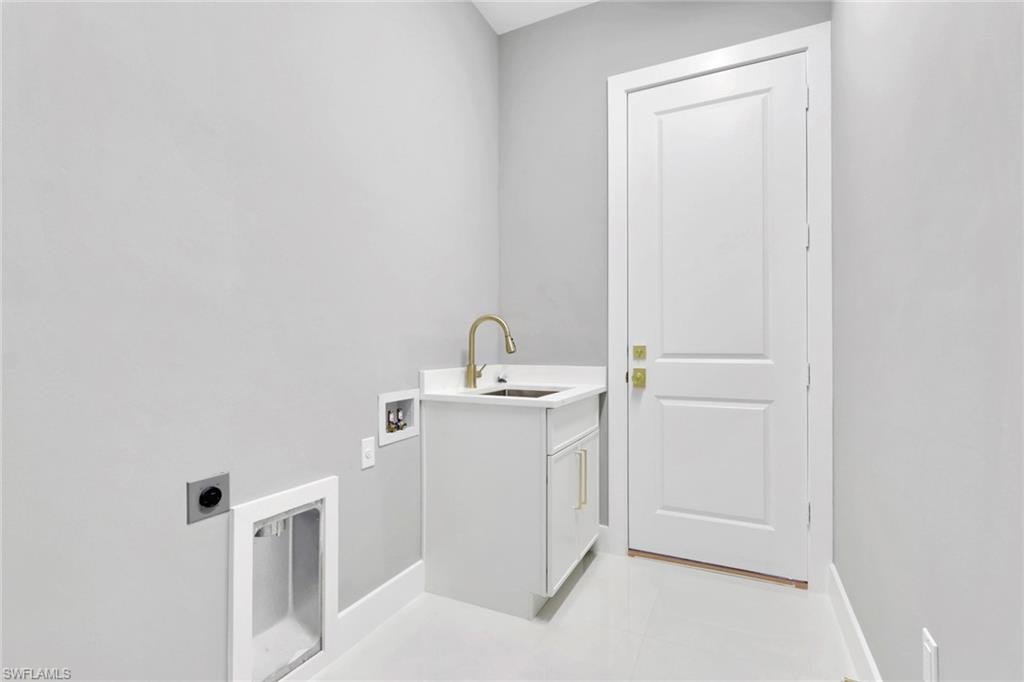 160 Logan Boulevard South Naples, FL 34119 - Photo 46 of 49 Laundry room with electric dryer hookup, hookup for a washing machine, cabinet space, and light tile patterned floors