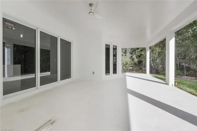 a view of an empty room with windows