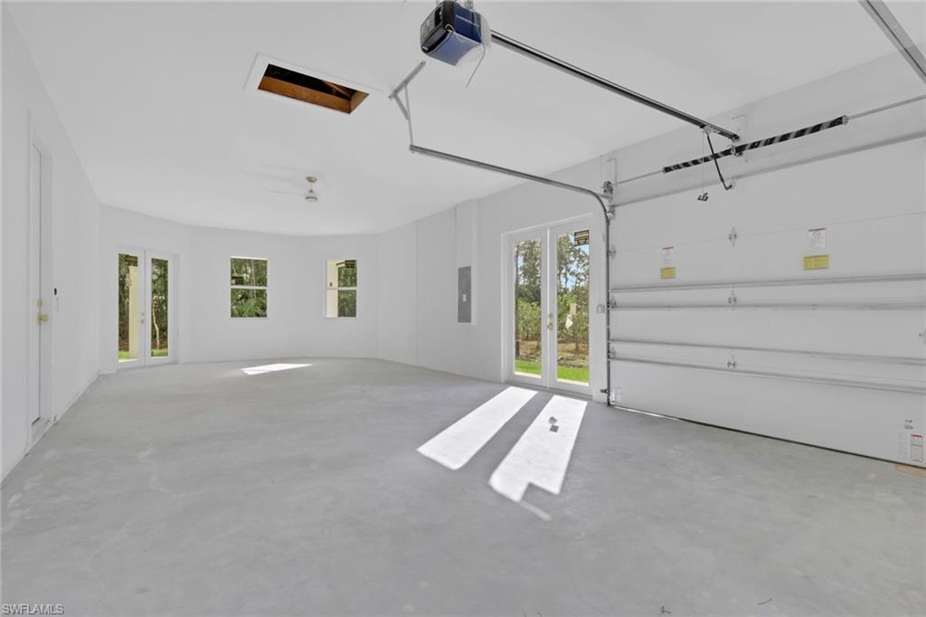 160 Logan Boulevard South Naples, FL 34119 - Photo 49 of 49 Garage with french doors, a garage door opener, and electric panel