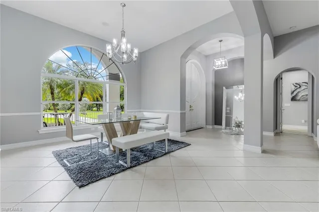 a living room with couches and a chandelier