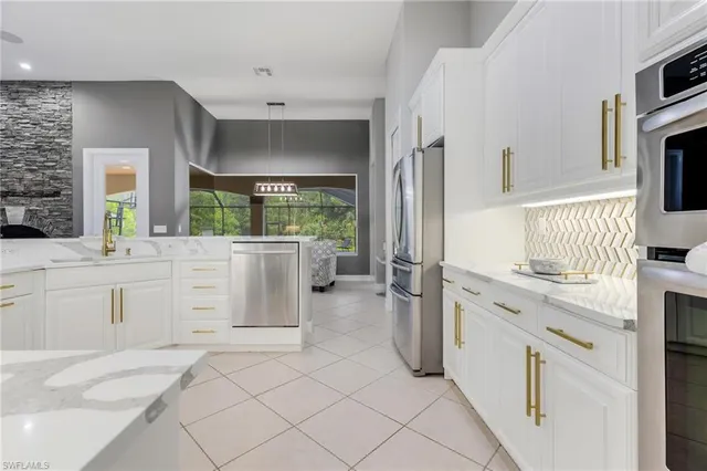 a kitchen with white cabinets and appliances