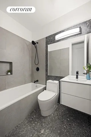a bathroom with a toilet a sink and bathtub