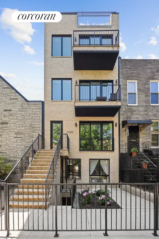 a view of a brick house with large windows