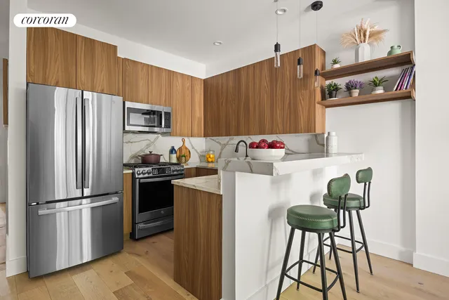 a kitchen with stainless steel appliances a refrigerator a stove a sink and a oven