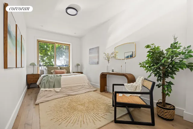 a bedroom with a bed and a potted plant