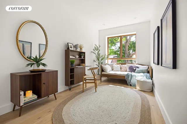 a living room with furniture a window and a flat screen tv