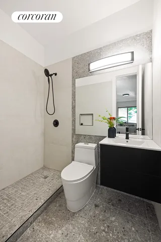 a bathroom with a sink toilet and shower