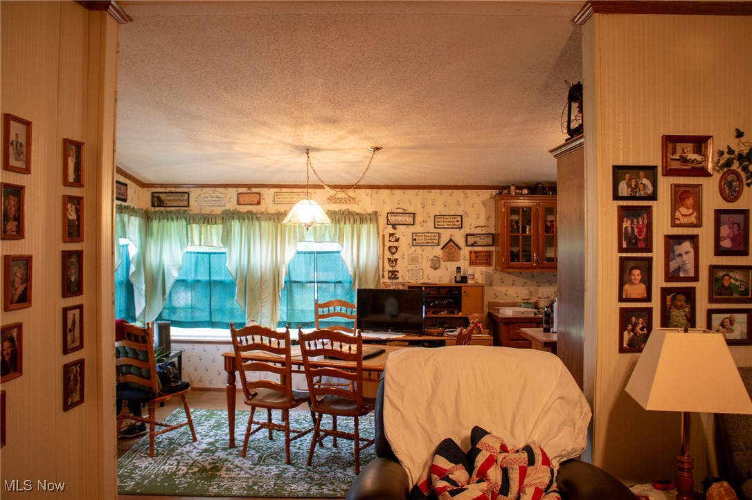 61691 Wintergreen Road Lore City, OH 43755 - Photo 25 of 50 Living room with wallpapered walls and a textured ceiling