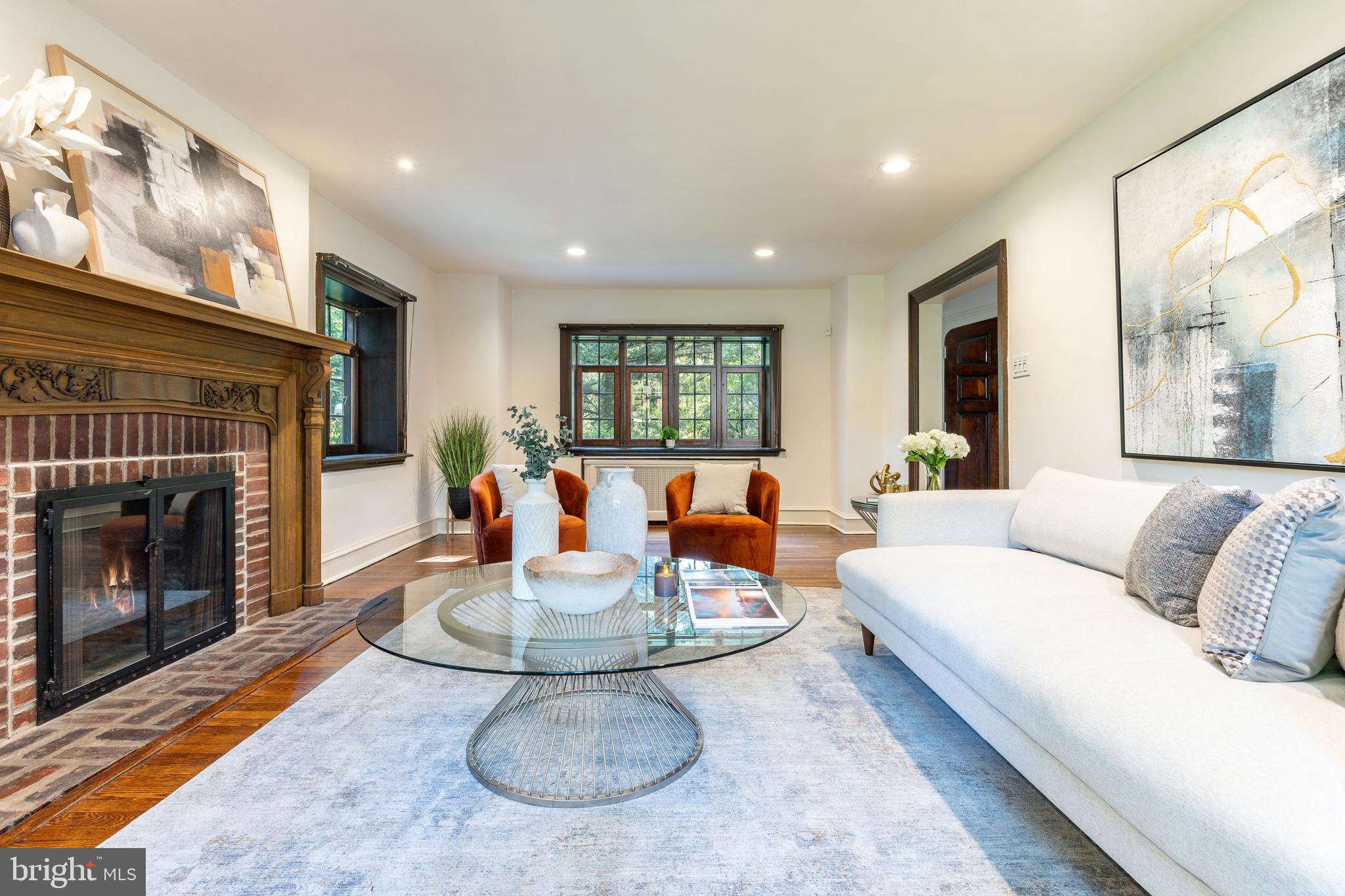 1419 County Line Road Bryn Mawr, PA 19010 - Photo 15 of 65 a living room with furniture a fireplace and a large window