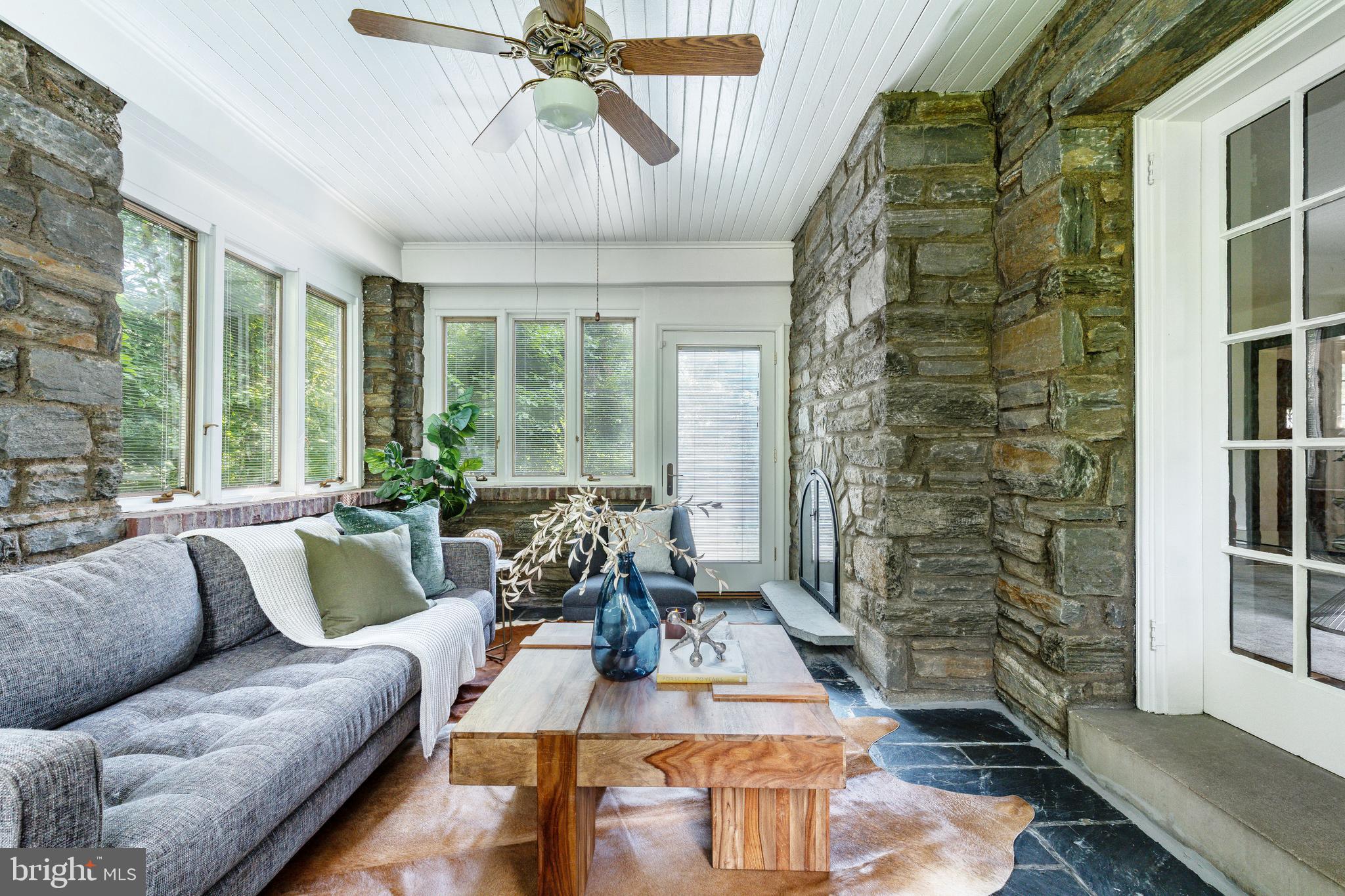 1419 County Line Road Bryn Mawr, PA 19010 - Photo 18 of 65 a living room with furniture and a floor to ceiling window