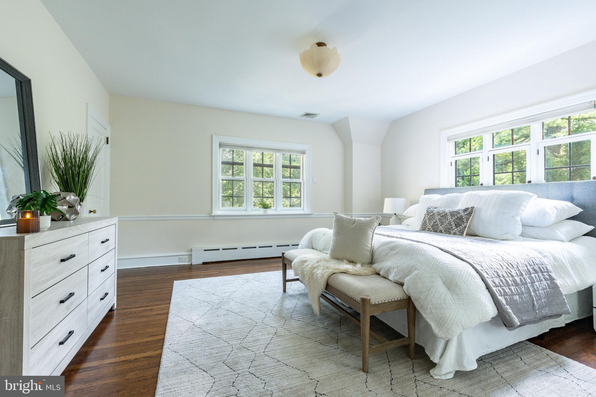 1419 County Line Road Bryn Mawr, PA 19010 - Photo 30 of 65 a spacious bedroom with a large bed and a window