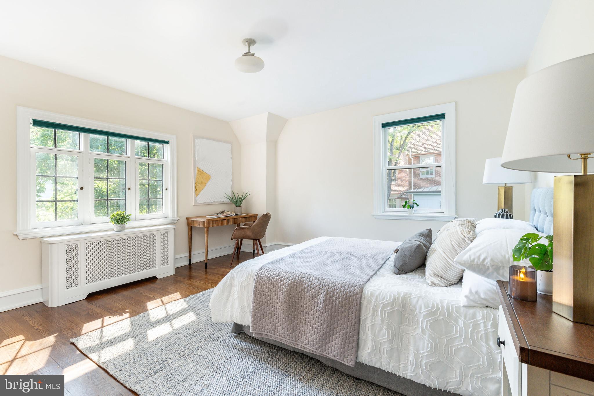 1419 County Line Road Bryn Mawr, PA 19010 - Photo 36 of 65 a bedroom with a bed wooden floor and windows