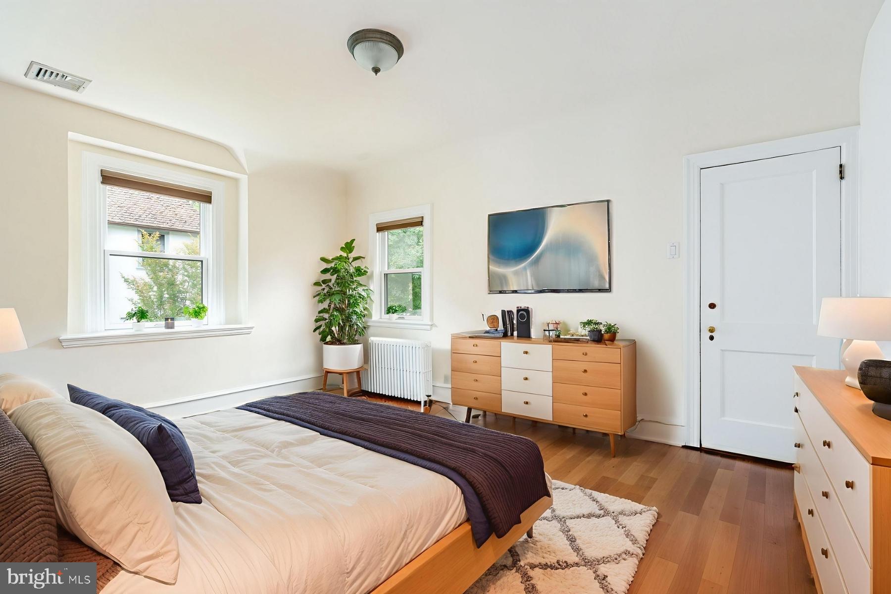 1419 County Line Road Bryn Mawr, PA 19010 - Photo 40 of 65 a bedroom with a bed and a flat tv screen on dresser