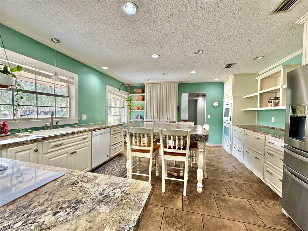 7625 East Misty Lane Inverness, FL 34450 - Photo 19 of 58 a large kitchen with a table and chairs