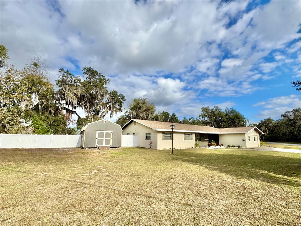 7625 East Misty Lane Inverness, FL 34450 - Photo 2 of 58 a view of white house with a yard