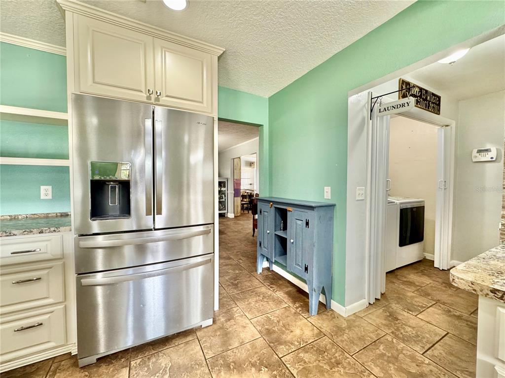 7625 East Misty Lane Inverness, FL 34450 - Photo 24 of 58 a kitchen with stainless steel appliances a refrigerator and cabinets