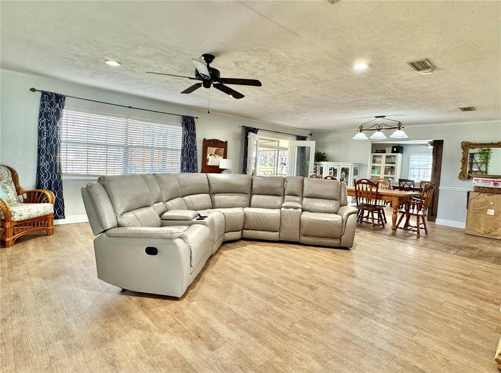 7625 East Misty Lane Inverness, FL 34450 - Photo 31 of 58 a living room with furniture and a large window