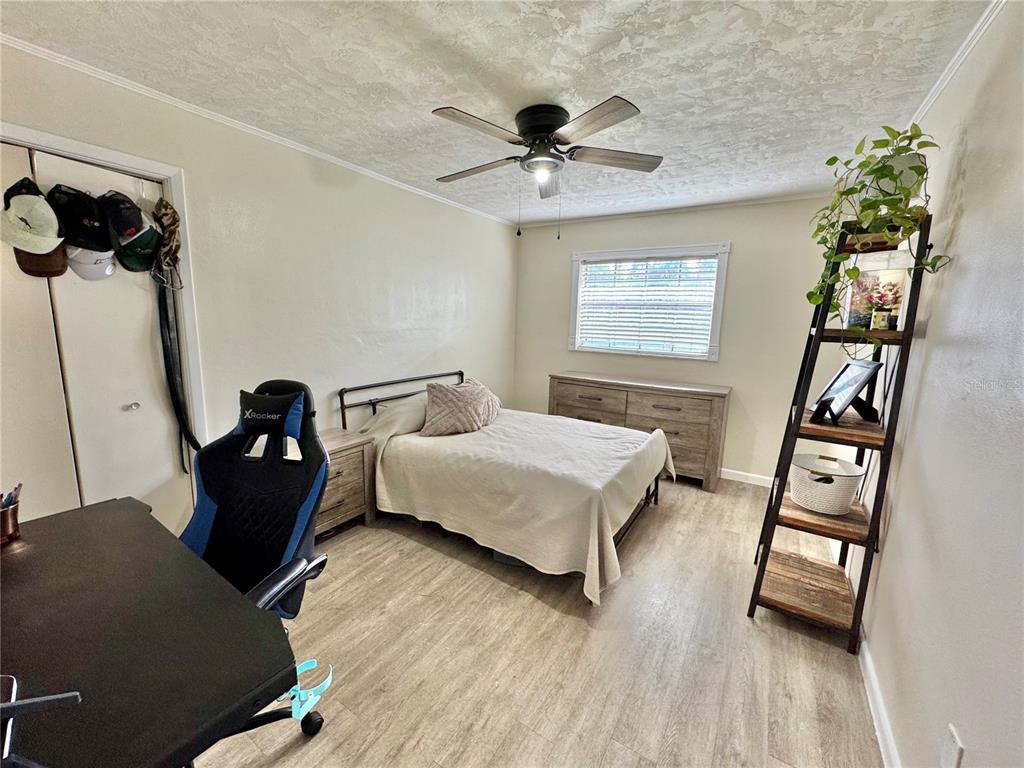7625 East Misty Lane Inverness, FL 34450 - Photo 35 of 58 a bedroom with a bed and wooden floor