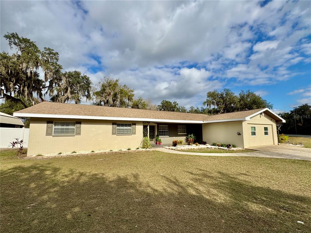 7625 East Misty Lane Inverness, FL 34450 - Photo 4 of 58 a front view of house with yard and trees around