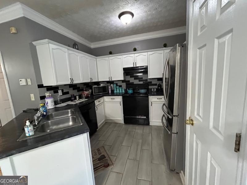 5099 Leeshire Trace Tucker, GA 30084 - Photo 12 of 26 a kitchen with a sink appliances and cabinets
