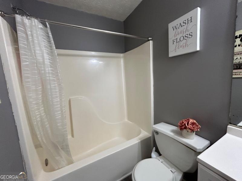 5099 Leeshire Trace Tucker, GA 30084 - Photo 16 of 26 a white toilet sitting next to a bath tub
