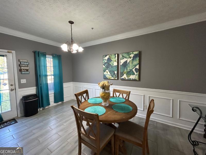 5099 Leeshire Trace Tucker, GA 30084 - Photo 19 of 26 a view of a dining room with furniture window and wooden floor