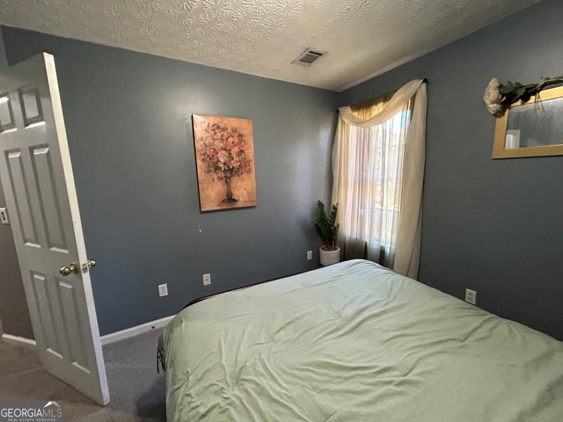5099 Leeshire Trace Tucker, GA 30084 - Photo 20 of 26 a bedroom with a bed and a window