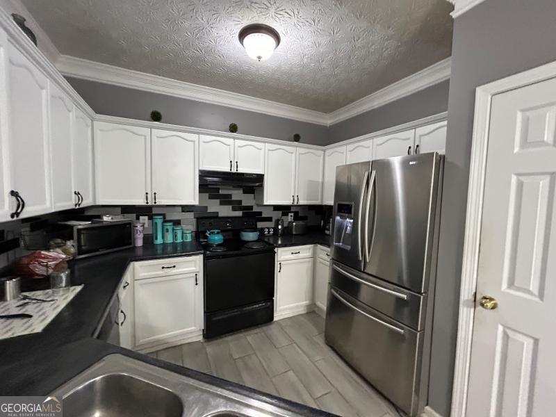 5099 Leeshire Trace Tucker, GA 30084 - Photo 2 of 26 a kitchen with stainless steel appliances a refrigerator sink and stove