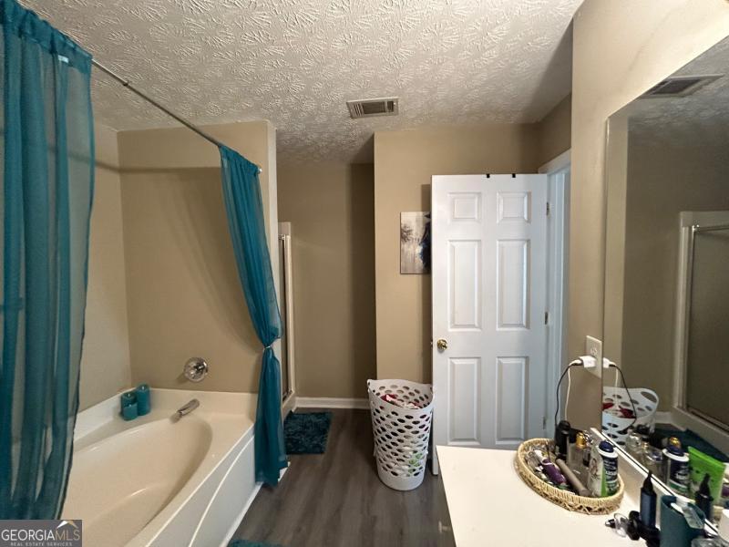 5099 Leeshire Trace Tucker, GA 30084 - Photo 5 of 26 a bathroom with a tub sink and mirror