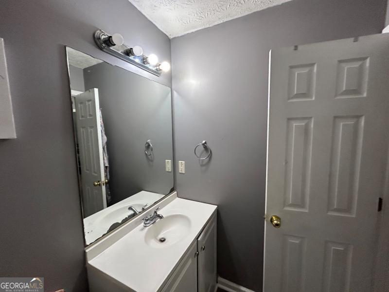 5099 Leeshire Trace Tucker, GA 30084 - Photo 6 of 26 a bathroom with a sink and mirror