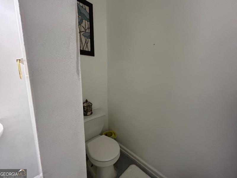 5099 Leeshire Trace Tucker, GA 30084 - Photo 9 of 26 a white toilet sitting next to a shower