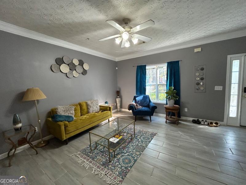 5099 Leeshire Trace Tucker, GA 30084 - Photo 10 of 26 a living room with furniture and a chandelier