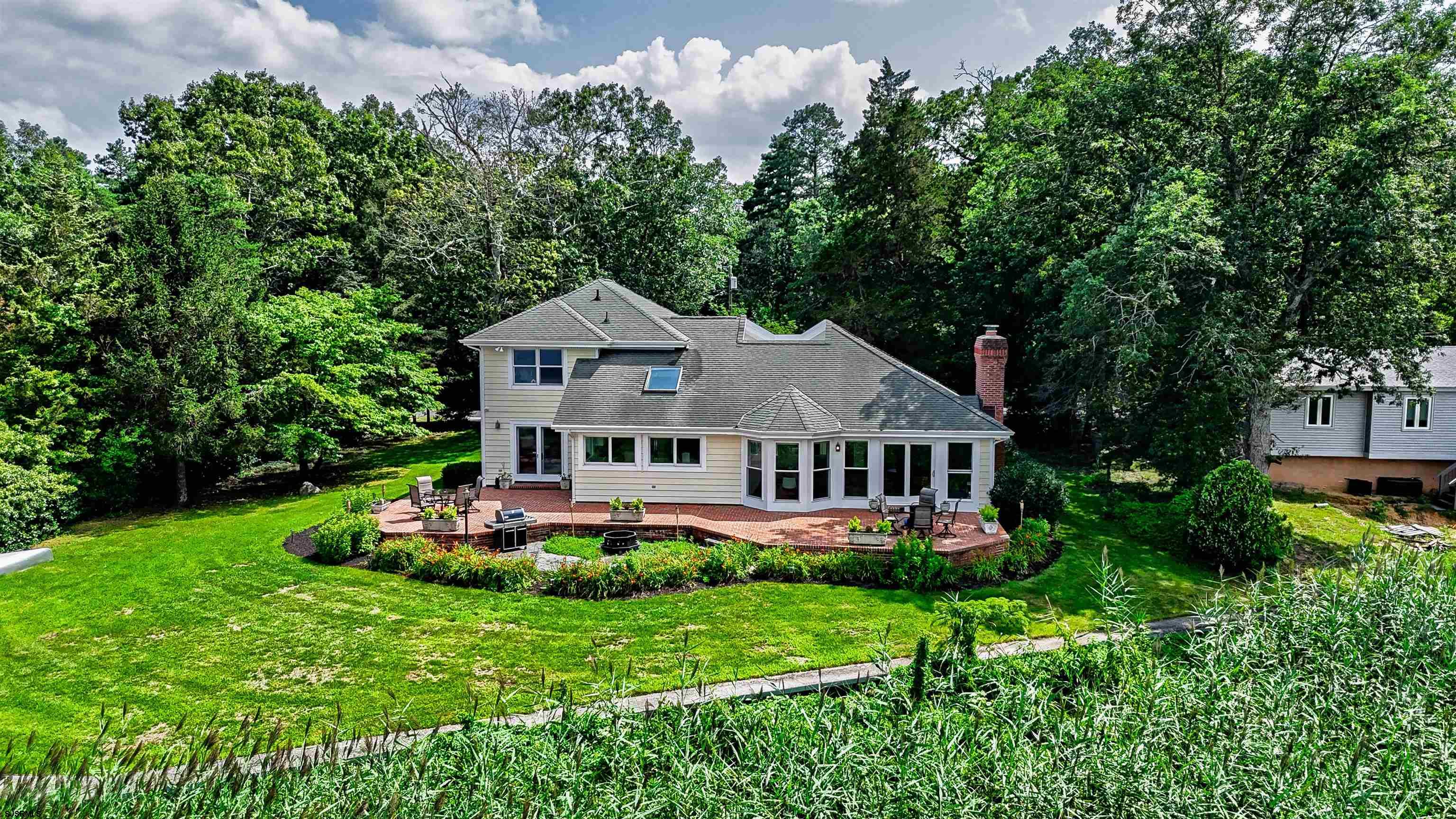 1303 West Riverside Drive Mays Landing, NJ 08330 - Photo 1 of 50 a front view of a house with a yard and potted plants