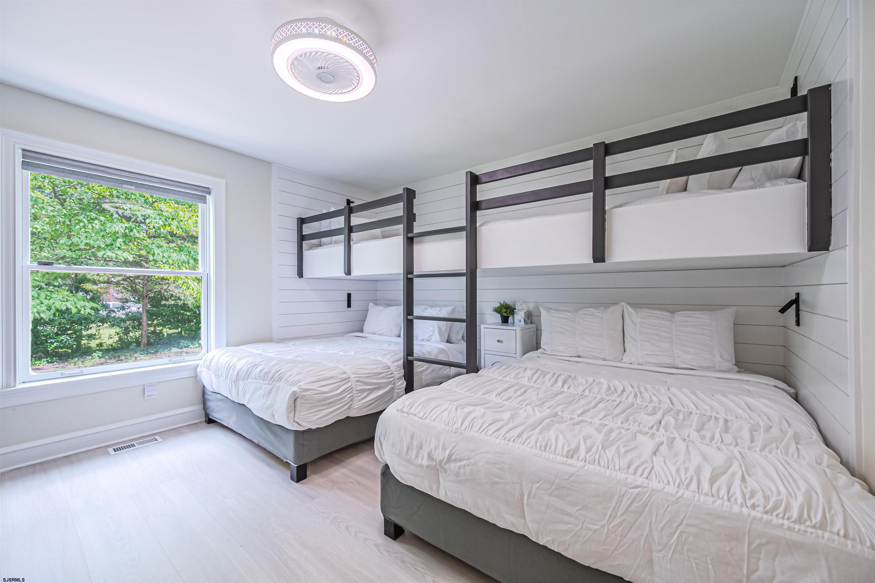 1303 West Riverside Drive Mays Landing, NJ 08330 - Photo 22 of 50 a bedroom with two beds and a large window