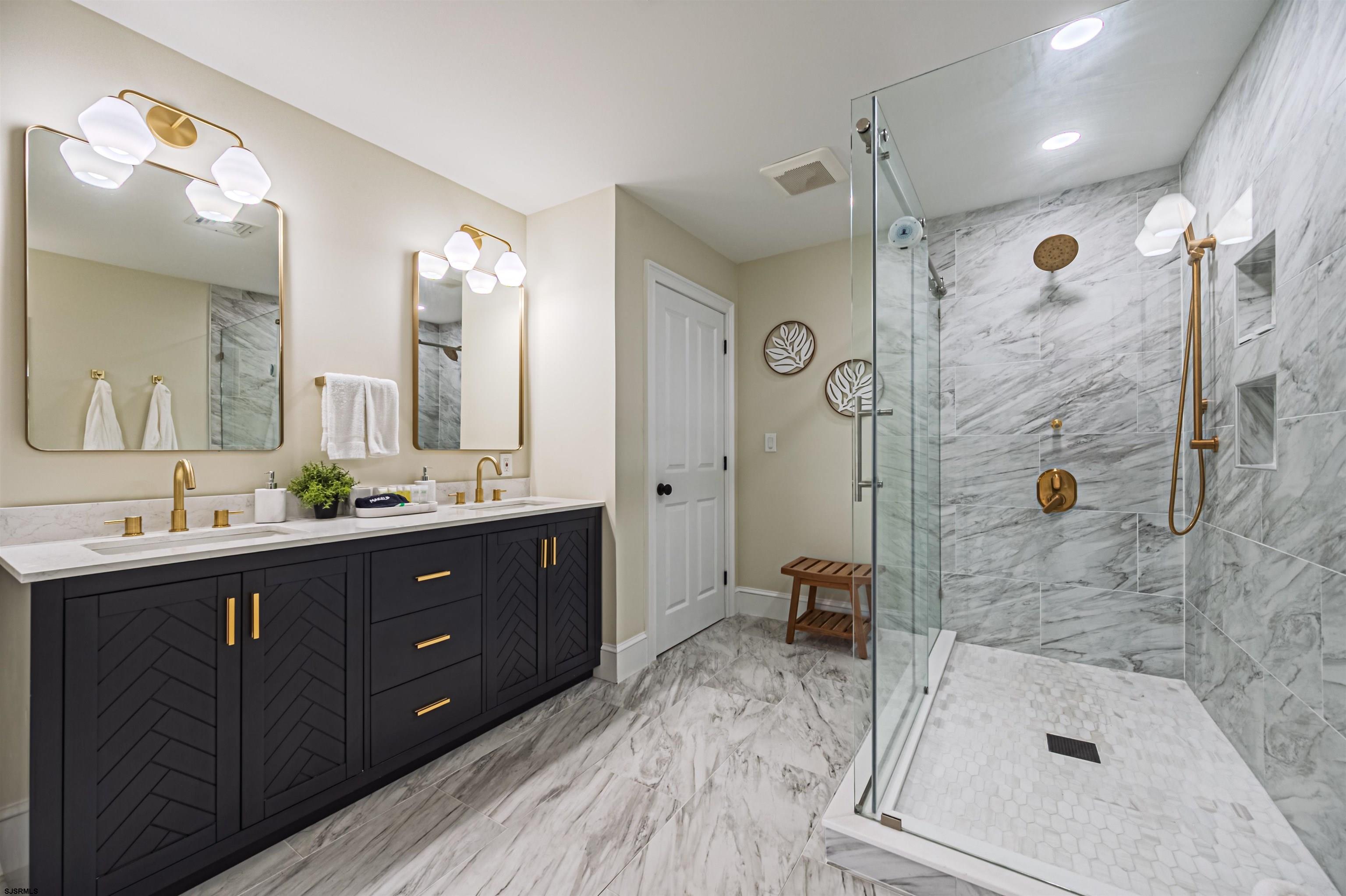 1303 West Riverside Drive Mays Landing, NJ 08330 - Photo 32 of 50 a bathroom with a sink double vanity granite tub shower and a mirror