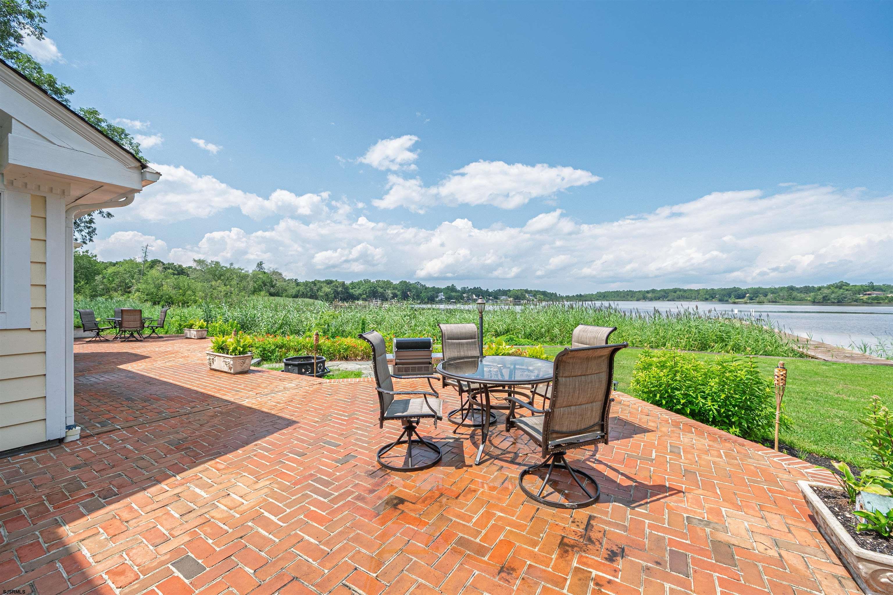 1303 West Riverside Drive Mays Landing, NJ 08330 - Photo 41 of 50 a view of a patio with a table chairs and a garden