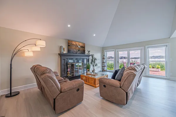 a kitchen with stainless steel appliances a stove a sink a stove a table and chairs