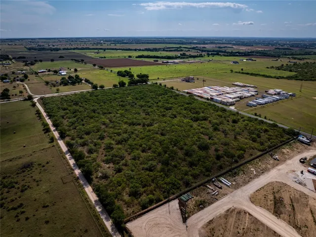 an aerial view of a residential houses with outdoor space