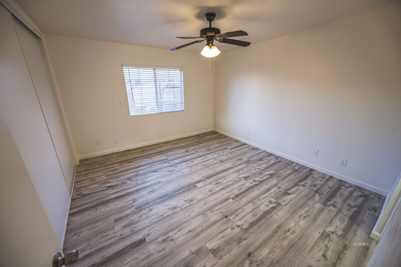 1213 Primrose Street Ridgecrest, CA 93555 - Photo 19 of 37 wooden floor in an empty room with a window